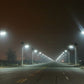 Solar-powered street lights on tall poles with bright LEDs