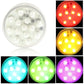 Round multi-color LED light with clear cover, lit blue, green, and purple bulbs