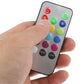 Hand holding multi-color LED remote control with colored preset buttons