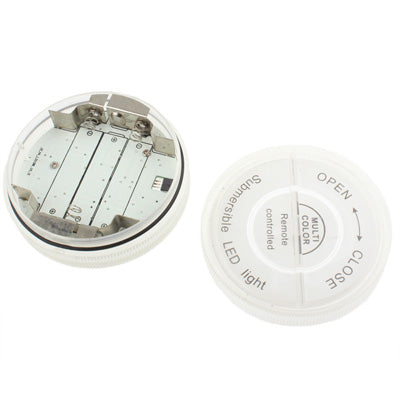 Round LED light base with exposed battery compartment and metal terminals