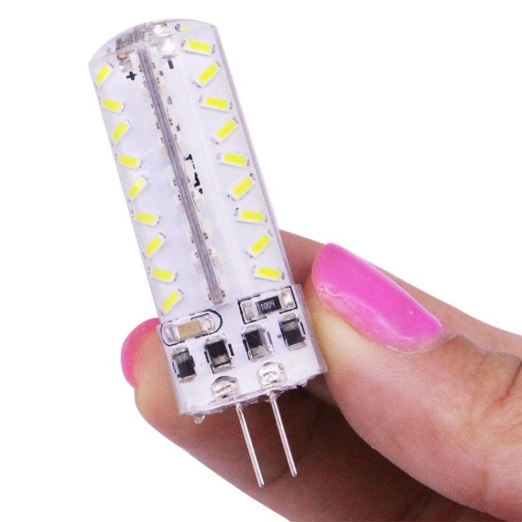 G4 LED light bulb held in hand, clear body with SMD LED row and two-pin base