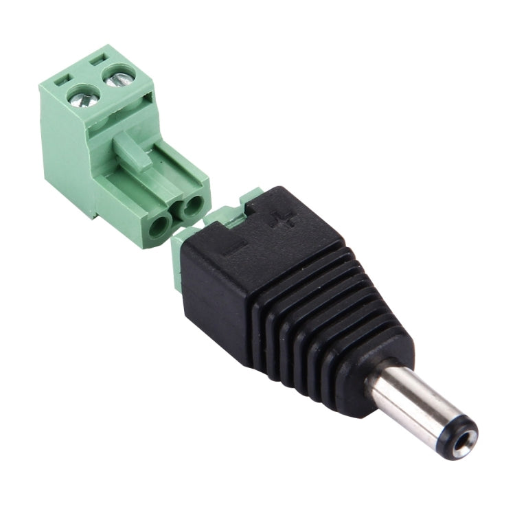 DC power male plug with black barrel, silver pin, and green screw terminal base