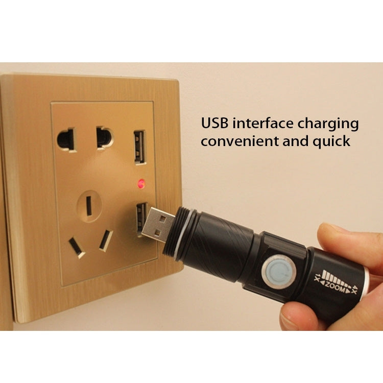 Black USB charging LED flashlight plugged into a wall outlet via USB cable