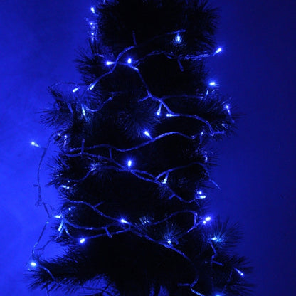 Blue LED string lights on a lit Christmas tree with tinsel branches