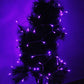 Purple LED string lights wrapped around dark green garland