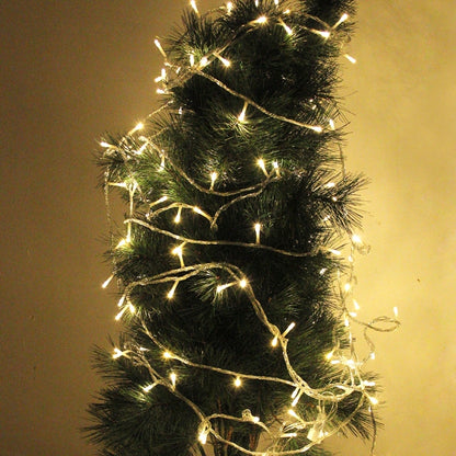 Battery LED string lights on dark green garland, warm white glow