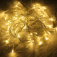 Warm white LED string lights on metallic wire, loose coil