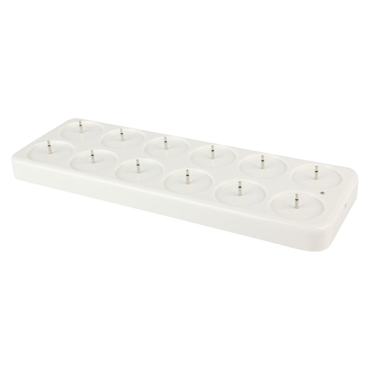 White charging dock with circular charging slots and metal pins for LED candles