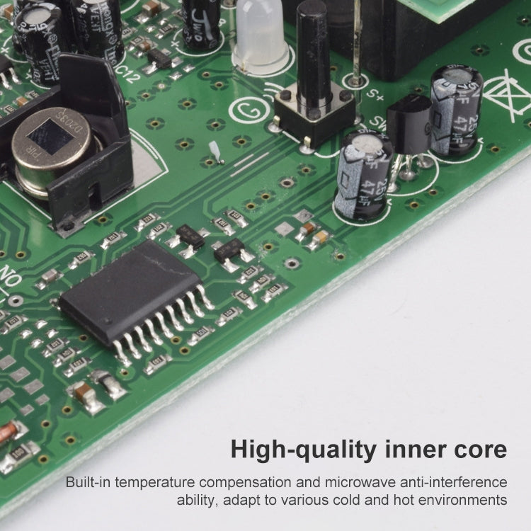 Green motion-sensor circuit board with ICs, capacitors, and connector pads