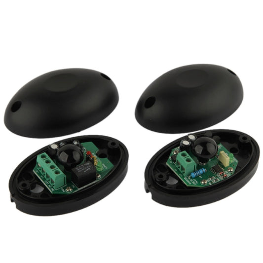 Active infrared beam detector sensor pair with black oval housings and mounting bases
