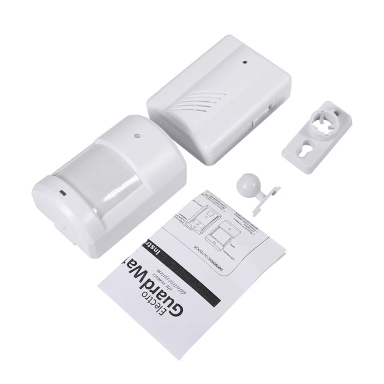 White wireless doorbell sensor, compact receiver, and instruction sheet with parts