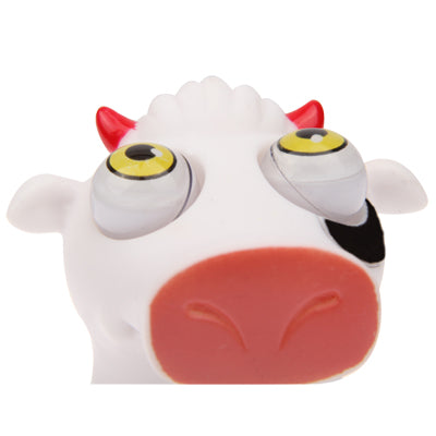 White pig eye toy figure close-up with yellow-ring eyes and red snout