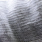 White cotton glove knit texture close-up with dense ribbed weave