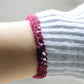 Cotton glove wrist cuff detail, white knit with magenta stitched trim