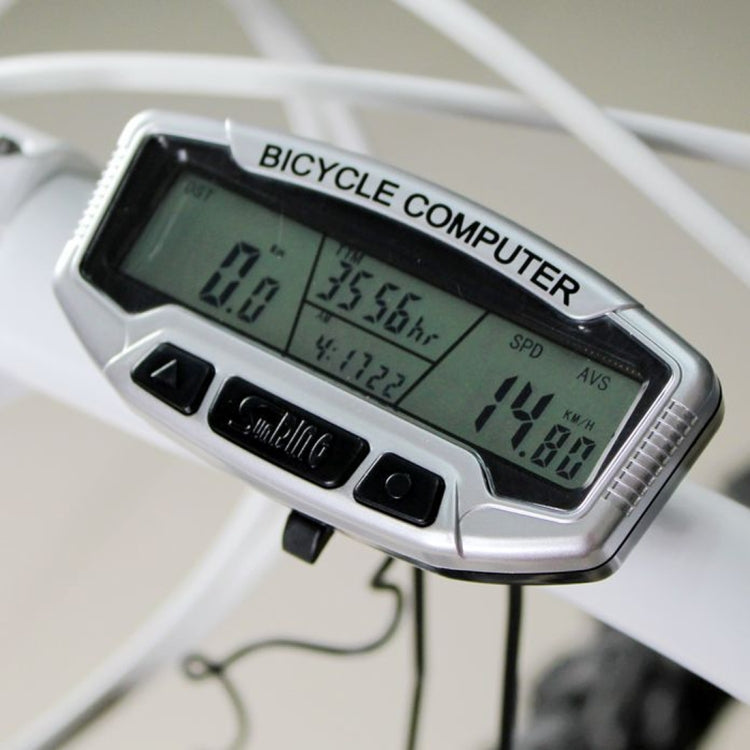 MANBUREN bicycle computer on handlebars with green LCD showing speed and distance