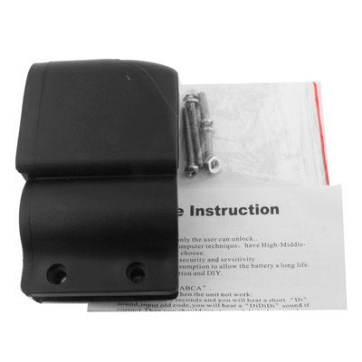 Black bicycle alarm housing with screw holes; includes instruction insert behind it