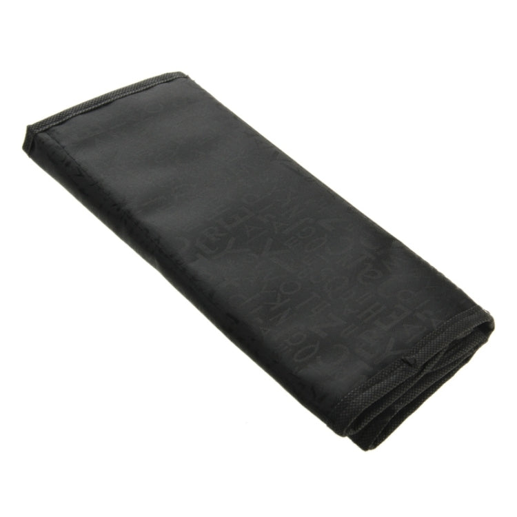 Black cosmetic organizer pouch rolled side view with embossed fabric texture