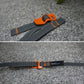 Dark gray strap with orange quick-release buckle on gray surface