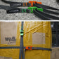 Two dark gray straps with orange and green quick-release buckles