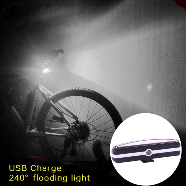 USB rechargeable bicycle LED taillight glowing, showing clear light bar detail