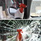 Hand holding orange emergency escape hammer at cracked car window glass