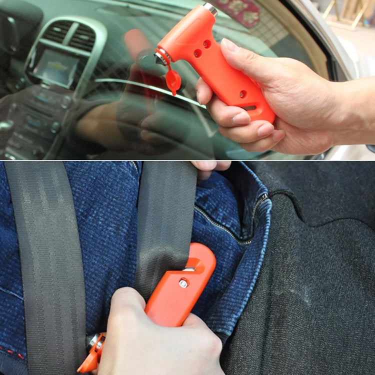 Orange emergency escape hammer cutting a seatbelt in a car interior, held by hand