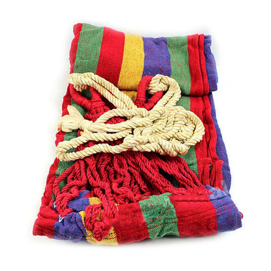 Folded multicolor striped canvas hammock with thick braided rope tie