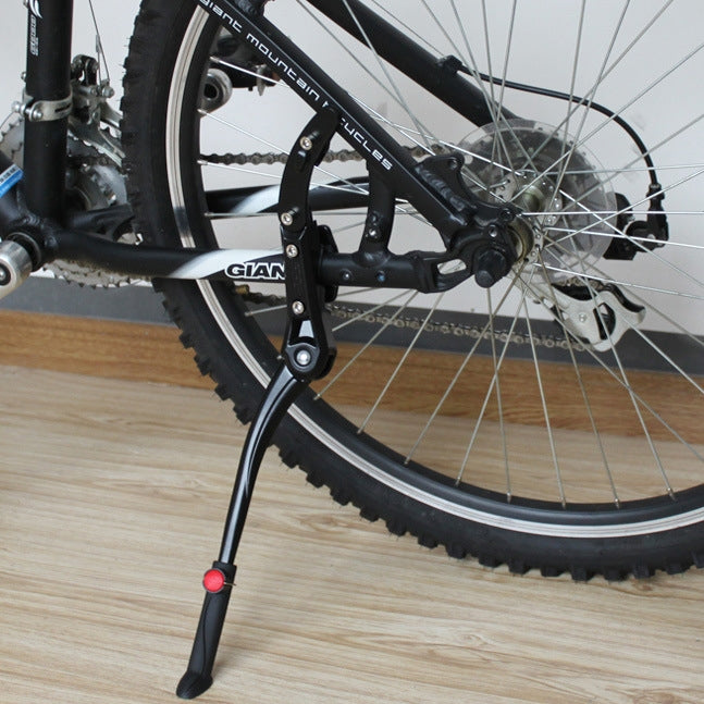 Adjustable black bicycle side kickstand with red release button for mountain bikes