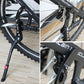 Black side kickstand mounting bracket and pivot bolts on a mountain bike frame