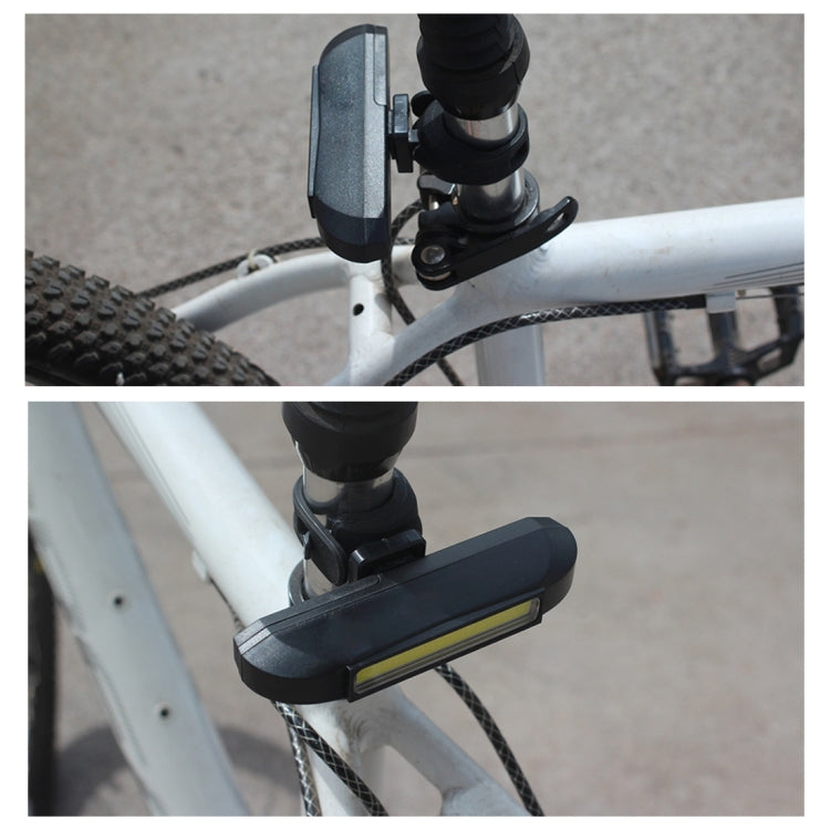 Bike-mounted black head light on handlebar bracket with adjustable mount