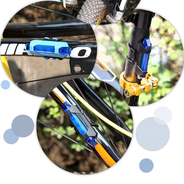 Blue bike taillight secured to seatpost with adjustable strap, LED module visible.