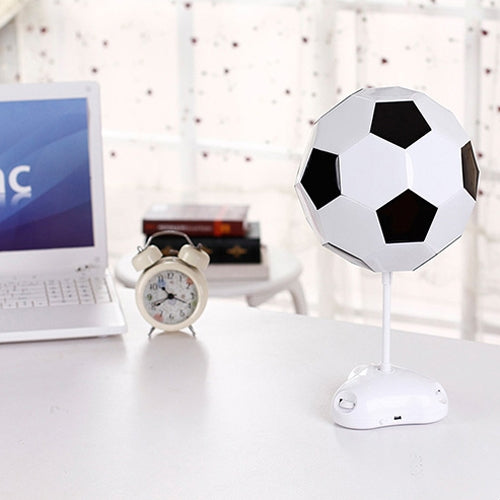 White soccer ball USB night light on desk stand with black pentagon panels.