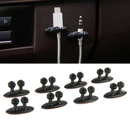 Black car cable bundle clips with adhesive, two clips holding cables on dashboard