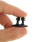 Black car cable bundle clip held between fingers for attaching to dashboard