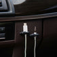 Black car cable bundle clips with adhesive attached to car dashboard near ports