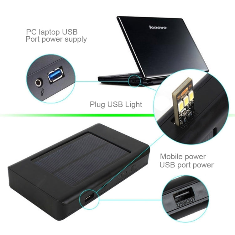 Black portable solar power bank with USB ports and a built-in LED light