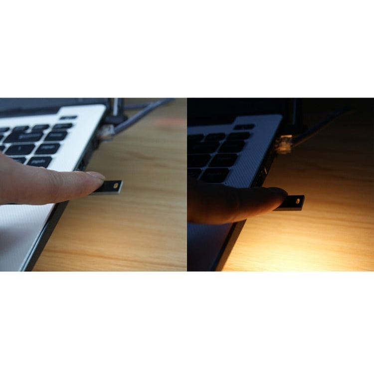 Hand inserting a USB plug into a portable solar LED light device