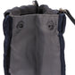 Dark navy cosmetic bag close-up of reinforced grommets and handle strap.
