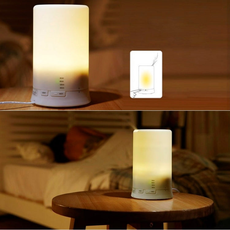 White aroma diffuser humidifier with warm LED light glowing from the base