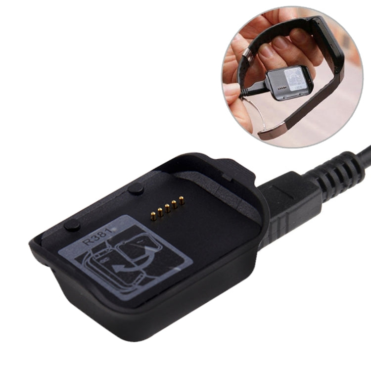 Black Bluetooth bracelet charging dock with visible charging pins and cable