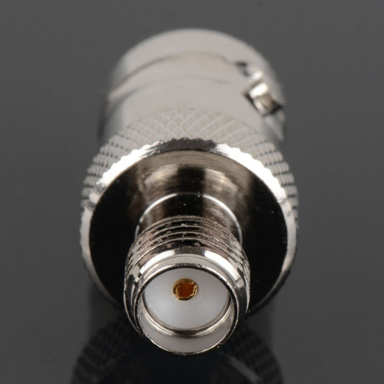 Close-up of SMA jack connector with knurled housing and gold center contact