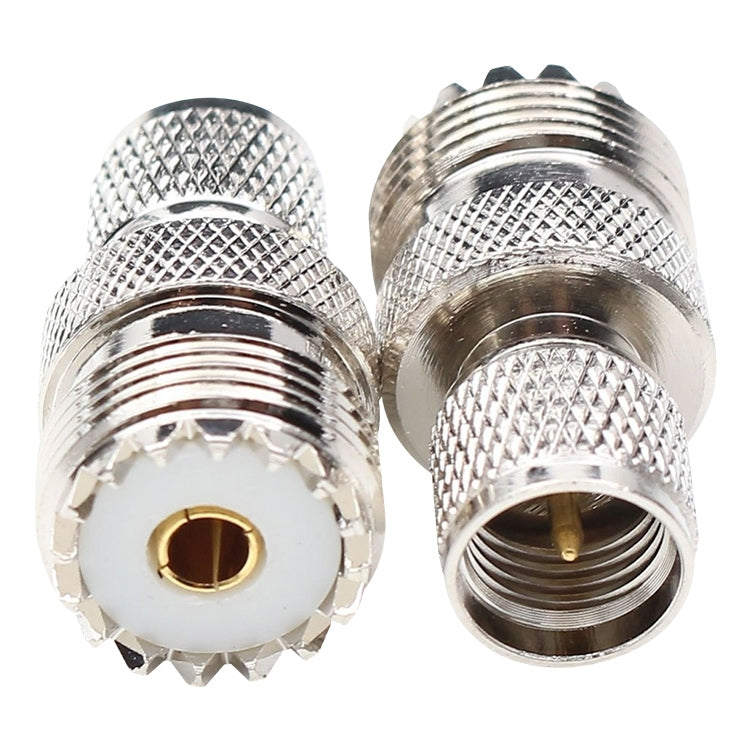 Close-up of UHF female and male connector ends, silver knurled housing, gold center pin