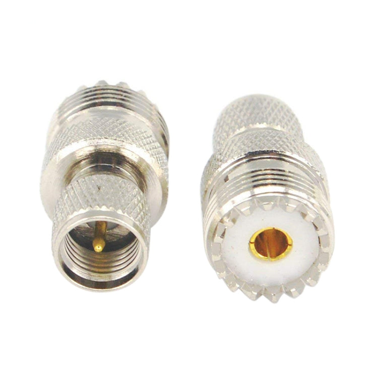 Silver UHF male-to-female RF coax adapter with gold contact center, two-piece view