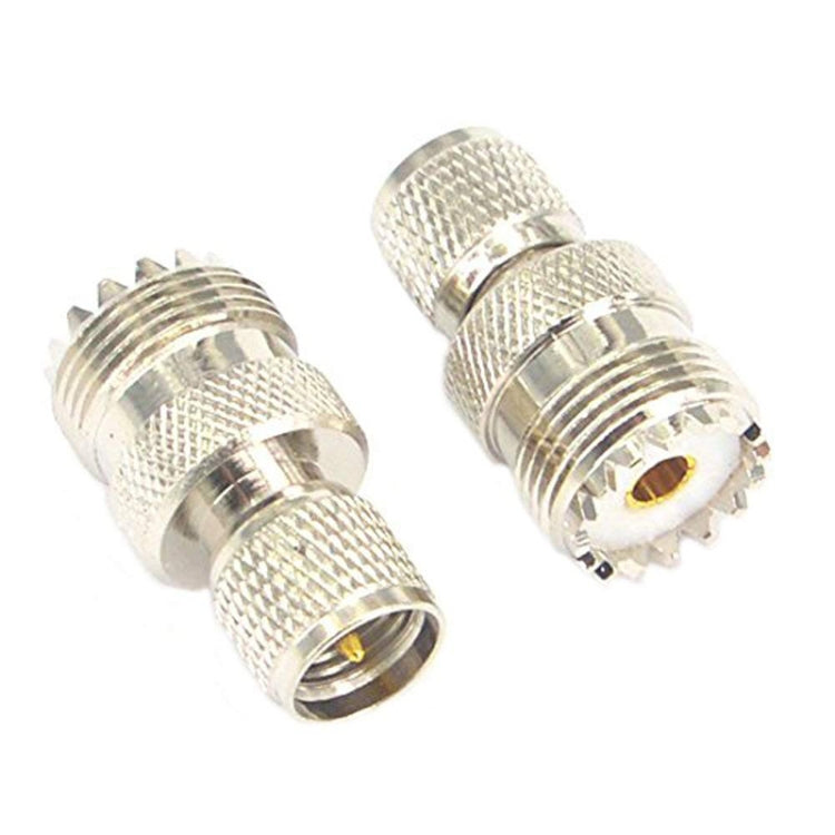 Silver RF coax adapter, UHF male and UHF female connectors side view with gold pin