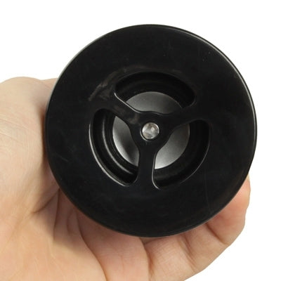Round speaker driver grille on black mini Bluetooth speaker lamp top