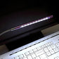 White LED light bar glowing above a keyboard area