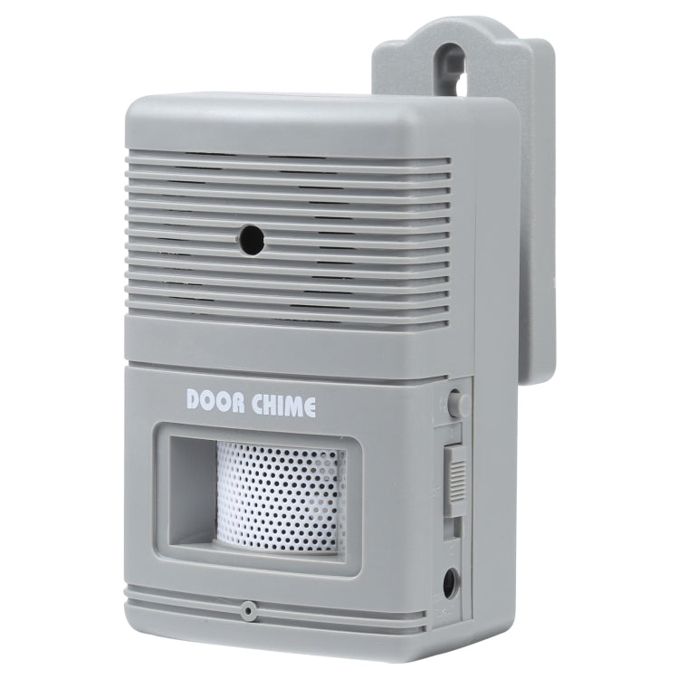 Wall-mounted wireless door chime alert unit, light gray speaker grille and side controls.