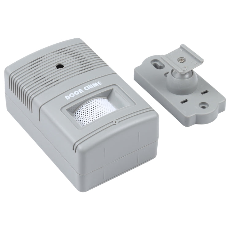Wireless door chime alert unit with plug base bracket and speaker front, light gray.