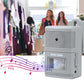 Wireless door chime alert unit with speaker face, light gray, positioned near doorway.
