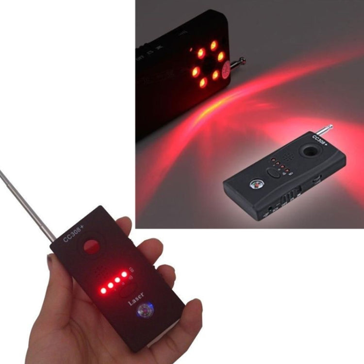 Handheld RF detector held in hand with glowing red LED array and visible antenna beam